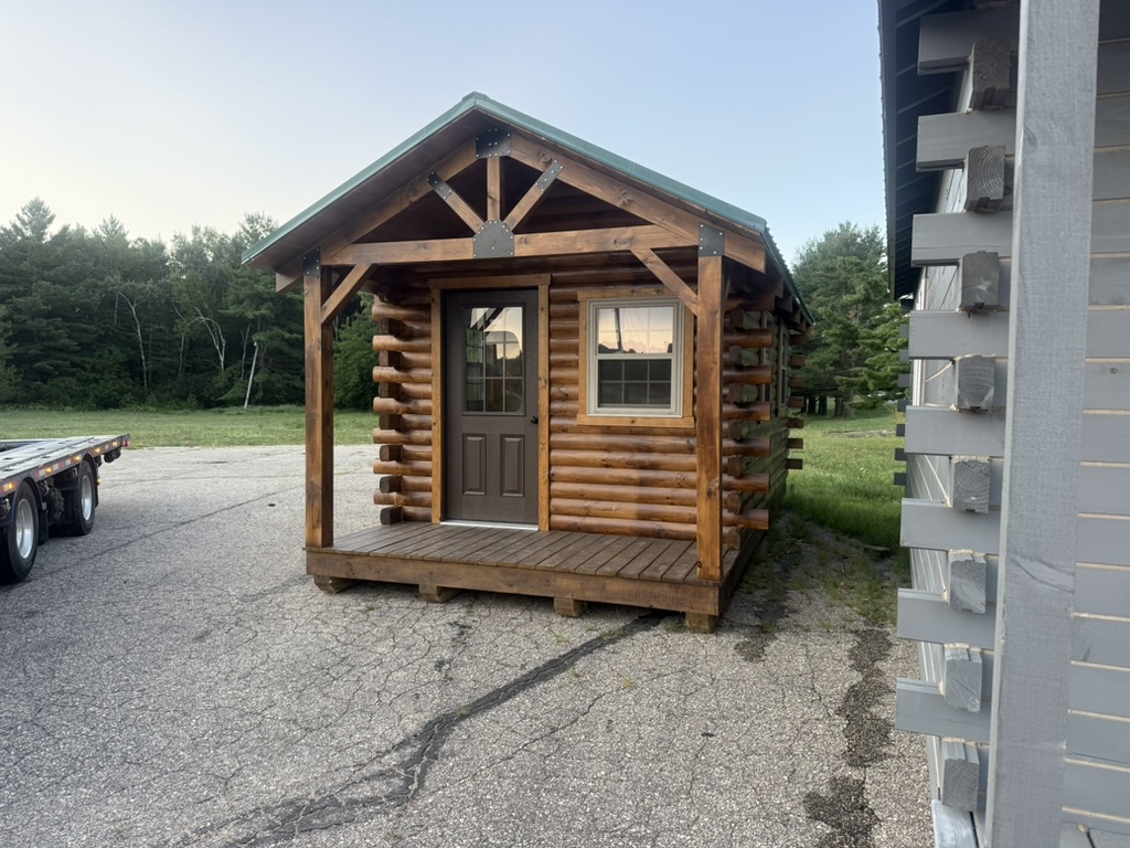 Front of the 10×20 d-log cabin with covered porch at the Tomah display lot