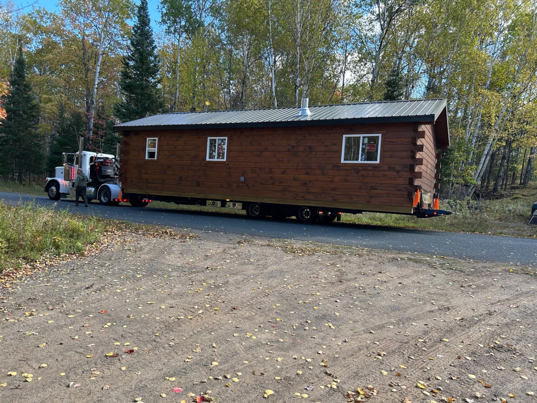 Single-level cabin delivered on trailer in the woods