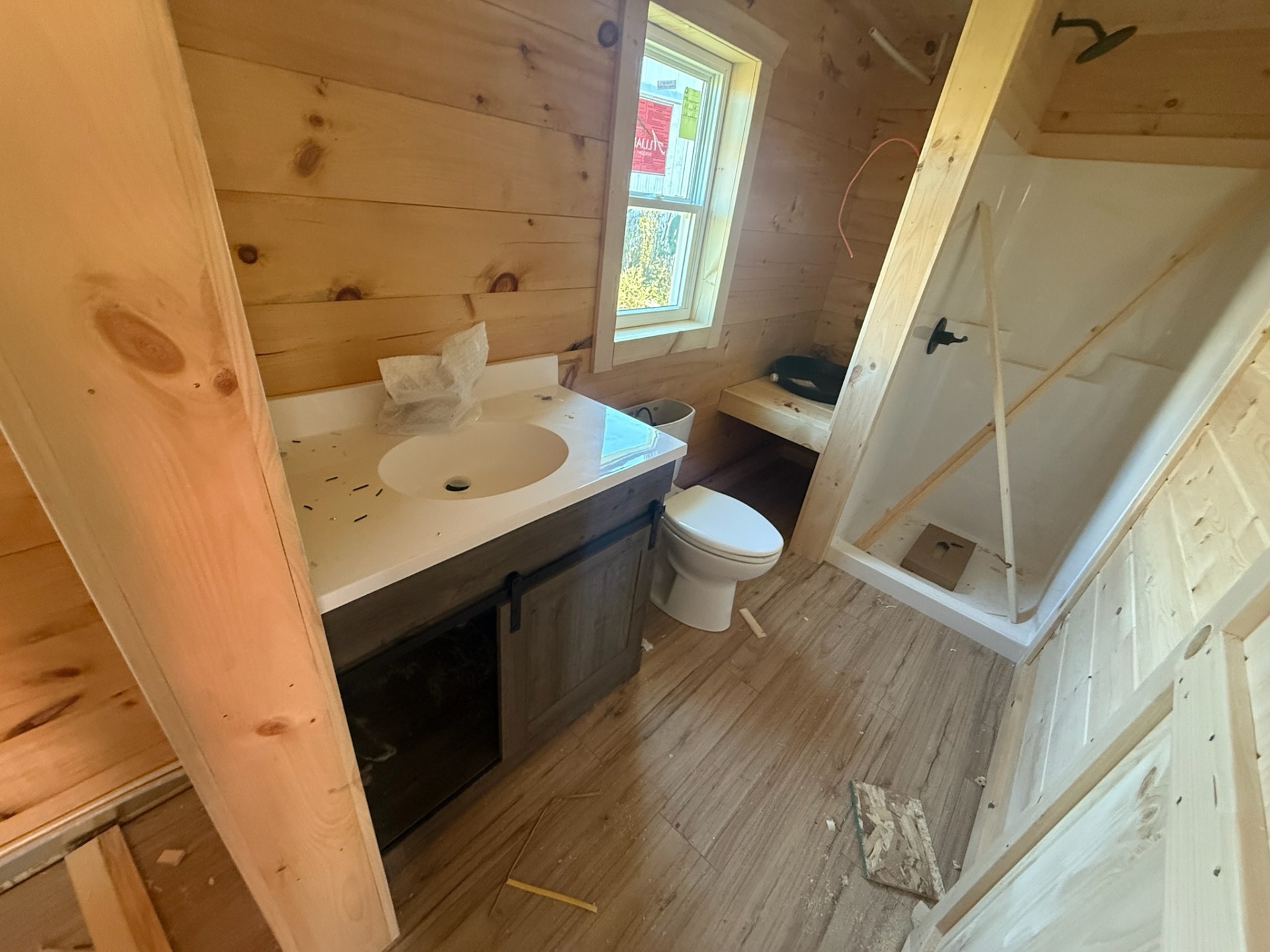 Finished bathroom with vanity, toilet and shower