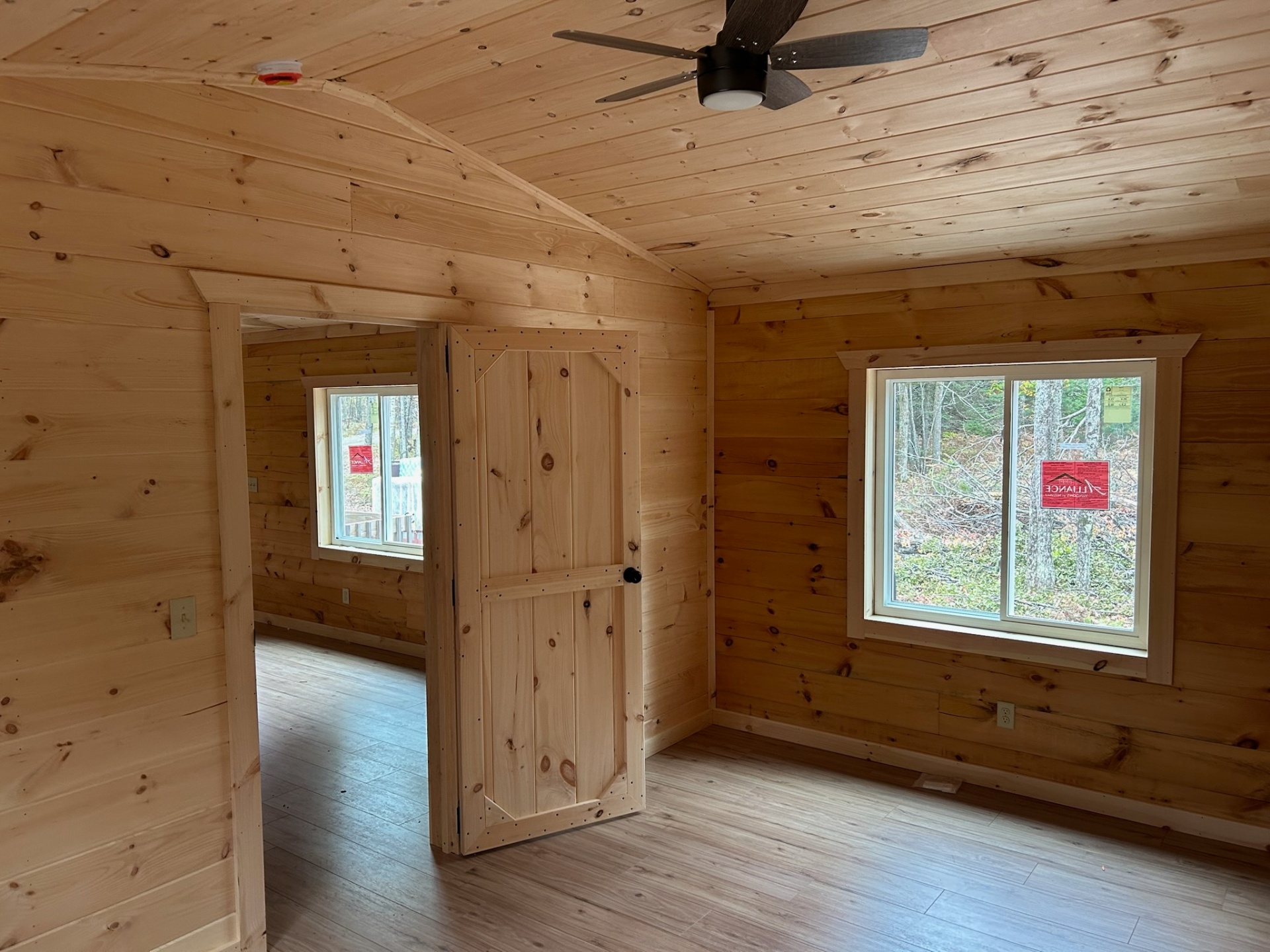 Bedroom interior with pine board door and windows