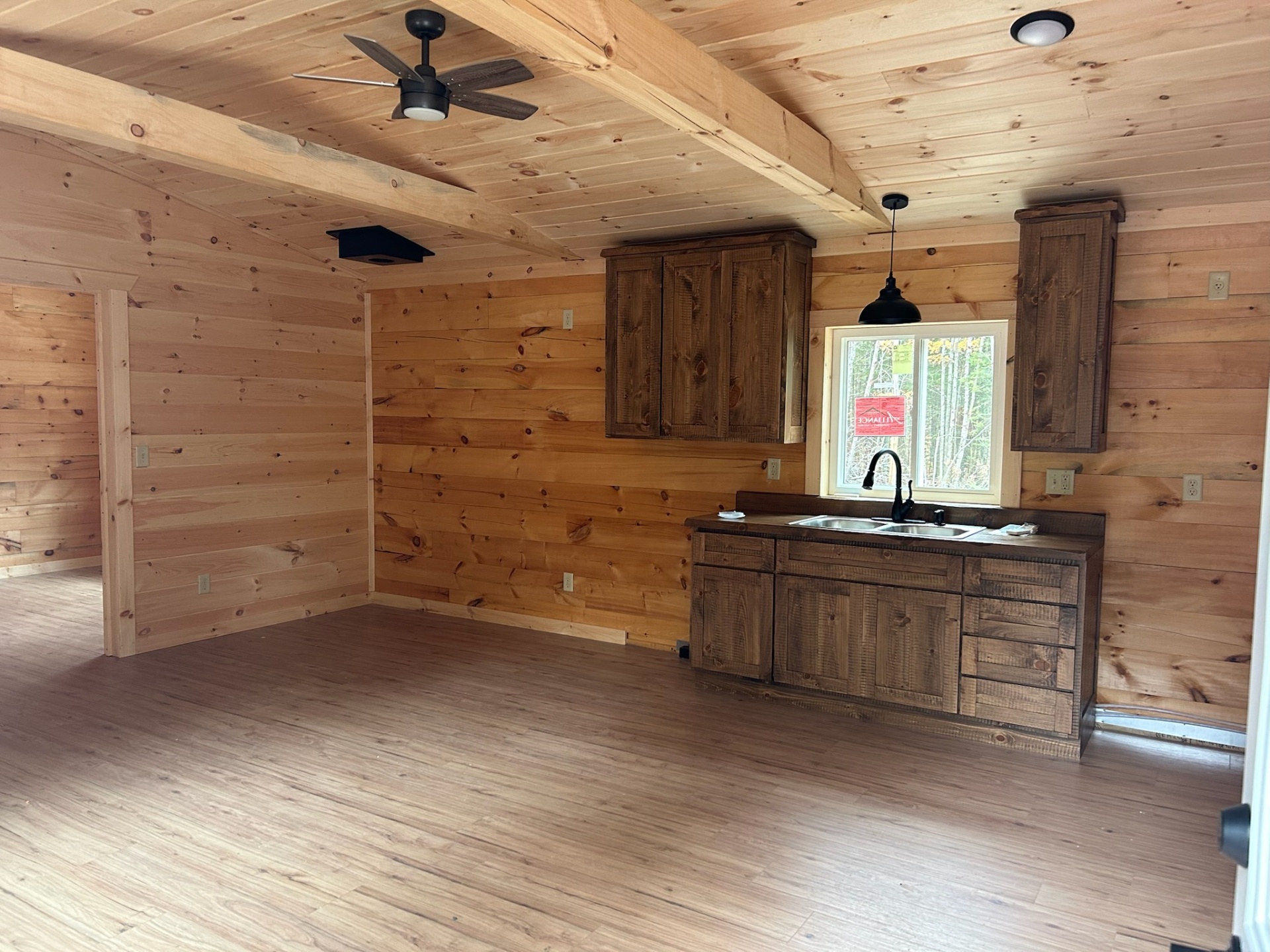 Kitchen with stained cabinets and pine walls
