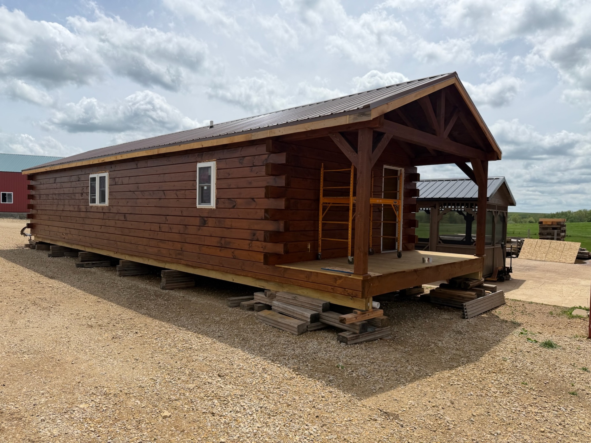 Long single-level log cabin with covered timber-frame porch