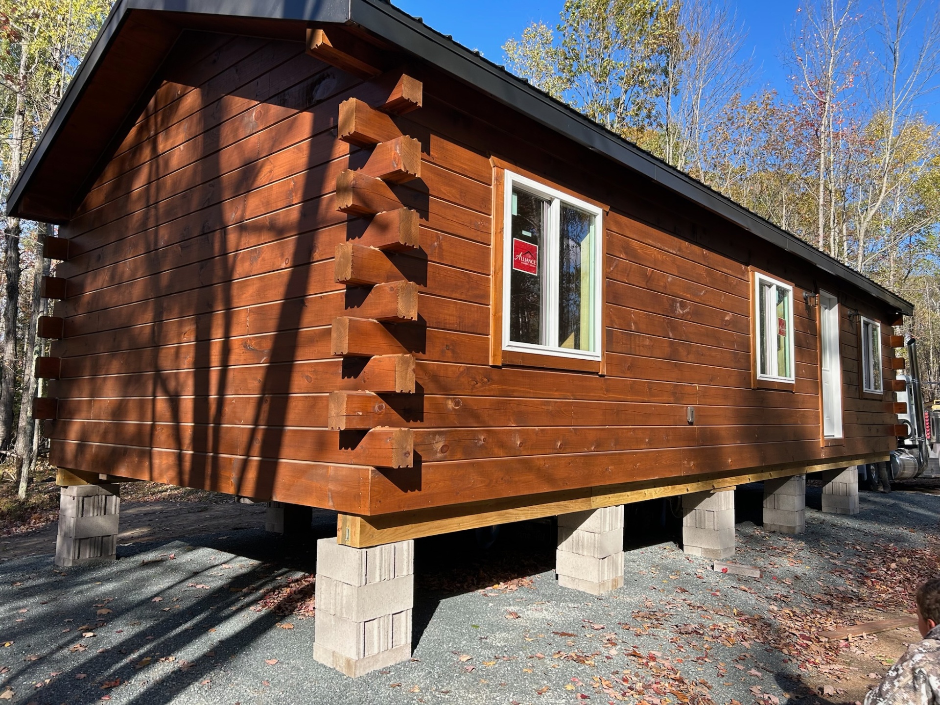 Single-level log cabin delivered and set on block piers